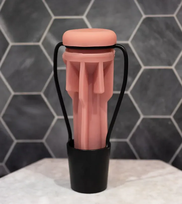 A Fleshlight sleeve standing upright to air dry on a clean surface